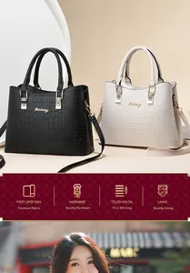 Detail of crocodile pattern leather tote bags with gold metal locks and branding
