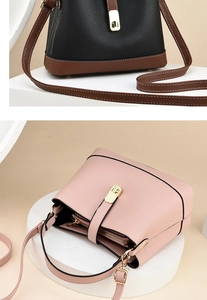 Detail of leather bucket bags with gold hardware and adjustable straps in beige studio