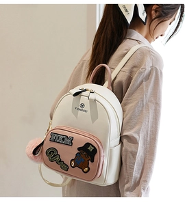 Close-up of mini backpack with pink bear sequin patch and side fur ball detail