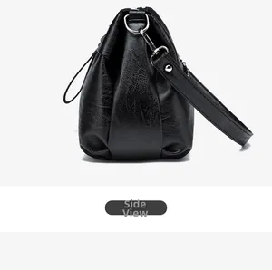 Side view of black grained PU leather handbag with silver metal buckles and stitching