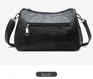 Back view of black faux leather crossbody bag with lychee texture and silver zipper pocket