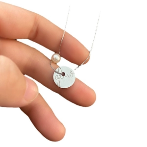 Minimalist titanium necklace with round pearl and engraved glow coin pendant in silver