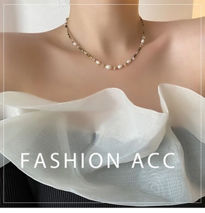 Detail shot of bohemian pearl necklace featuring mixed natural stones on a female model
