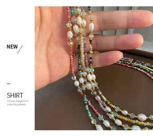 Detail of multi-layer beaded necklace with colorful crystals and baroque pearls