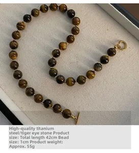 Tiger eye stone necklace with gold titanium steel accents shown in detailed macro curve