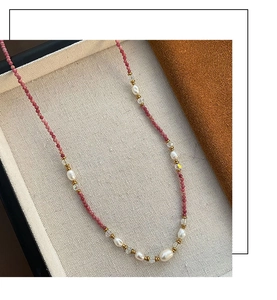 Detail of pink beads and irregular white pearls on a vintage bohemian choker necklace