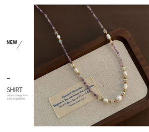 Detailed shot of mixed natural stones and pearls beaded necklace on a textured tray