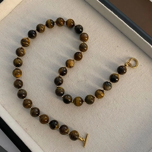 Tiger eye beaded necklace with gold metal spacers and OT buckle in a jewelry box