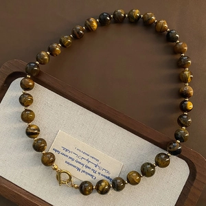 Elegant tiger eye beaded necklace for women with gold OT buckle and round pendant charm