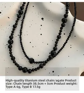 Detail showing two sizes of black agate beaded necklaces with titanium steel clasps