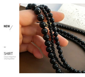 Macro shot of multi-layer black bead necklace with polished obsidian-style finish