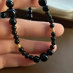 Elegant black agate necklace with gradient beads and hollow golden metal spacer beads