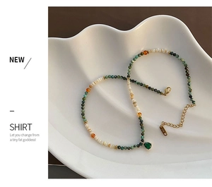 Detail of beaded necklace with green teardrop pendant and K18 gold lobster clasp