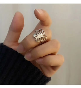 Close-up of a silver hollow butterfly ring in polished metal on a female finger