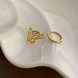 Chic 18k gold plated hollow butterfly ring set on elegant white ceramic jewelry plate