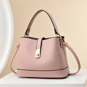 Elegant pink pebbled leather bucket bag with top handle and gold turn-lock closure