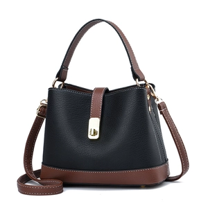 Fashionable black and brown contrast leather bucket bag with top handle and gold clasp