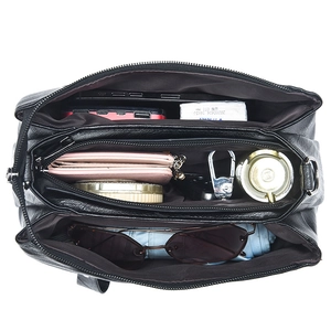 Three-compartment black leather shoulder bag showing large capacity for daily essentials