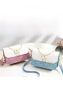 Detail of pink and blue sequin bags with white leather flap and pearl cat charm