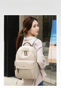 Classic beige oxford cloth backpack with brown leather details for women's daily commute