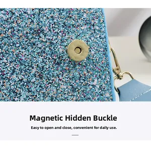 Detail of blue sequin bag showing secure gold magnetic snap closure and texture