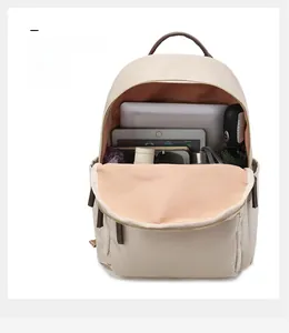 Internal view showing the spacious storage compartments of the beige Oxford fabric backpack