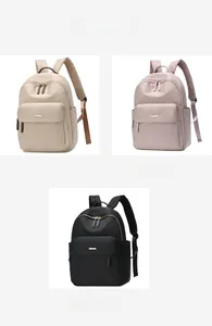 Detailed view of waterproof nylon backpacks in khaki, pink, and black with golden zippers