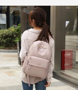 Detail of lavender oxford fabric backpack showing side pocket and adjustable shoulder straps