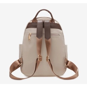Rear view of beige nylon backpack featuring brown leather straps and anti-theft zipper pocket