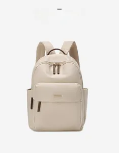 Classic cream oxford backpack featuring brown leather accents and side pockets