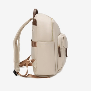 Detail view of beige nylon backpack side pocket and durable dark brown stitching accents