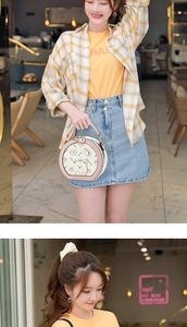 Detail of printed bear motif and HONGSHIJIA lettering on circular crossbody handbag