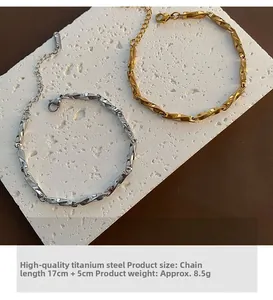 Detail view of gold and silver Mobius titanium steel bracelets with lobster clasp and chain