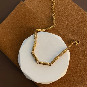 Golden Mobius titanium steel bracelet with twisted rectangular links and lobster clasp