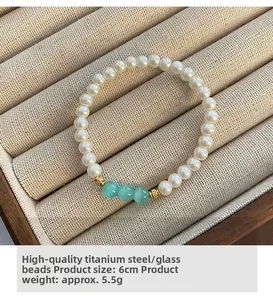 Macro shot of glass beaded titanium steel bracelet with blue beads on beige velvet tray