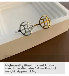 Macro shot of titanium steel Gemini rings in gold and silver on white display steps