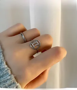Close-up of Gemini two-piece silver titanium steel ring set worn by model
