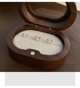 Three pairs of polished sterling silver stud earrings in a wooden jewelry gift box