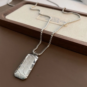 Minimalist silver rectangle pendant necklace with geometric texture on a box chain