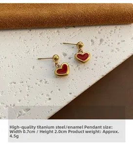 Detail of red heart earrings in gold-plated titanium steel with size 0.7x2.0cm