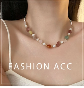 Close-up of bohemian beaded necklace with natural freshwater pearls and colorful gemstones