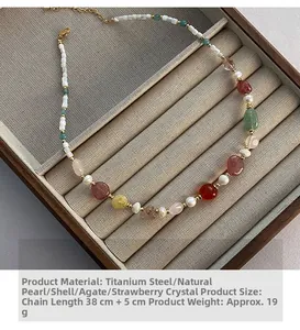 Detail of beaded necklace with natural pearls, agate and strawberry crystal on a display tray