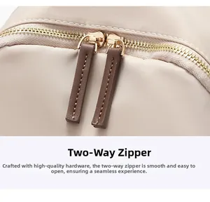 Detail of premium dual golden zippers with long brown leather pullers on beige backpack