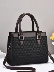 Brown geometric patterned tote bag with dual handles and gold hardware on grey background