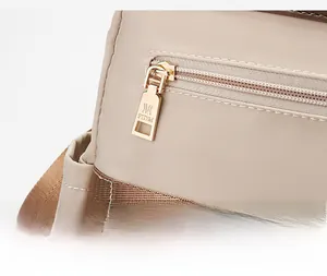 Detailed close-up of high-quality metal zipper pull with logo on oxford backpack