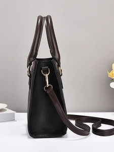 Litchi texture black and brown leather handbag with gold metal hardware and strap detail