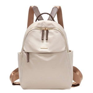 Minimalist beige nylon backpack with brown straps and golden metal logo hardware