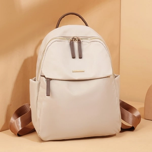 Chic cream nylon backpack with brown straps and gold hardware for women's travel