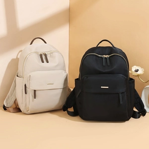 Minimalist oxford fabric backpacks in black and beige with durable metal logo accents