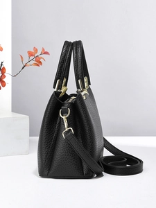 Minimalist black lychee texture handbag with gold hardware and versatile shoulder strap